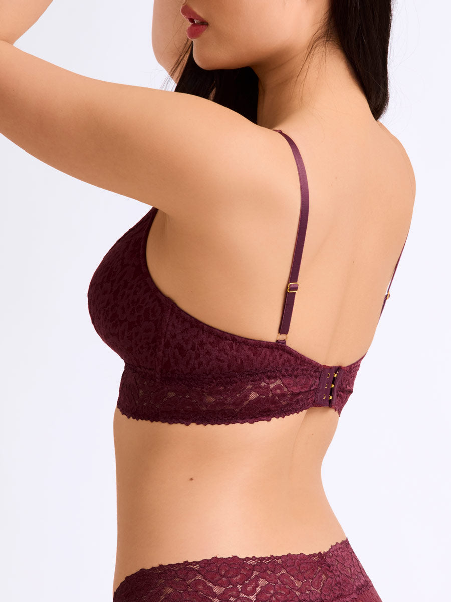 Woman wearing a maroon lace bralette from LoveSuze on a white background front view