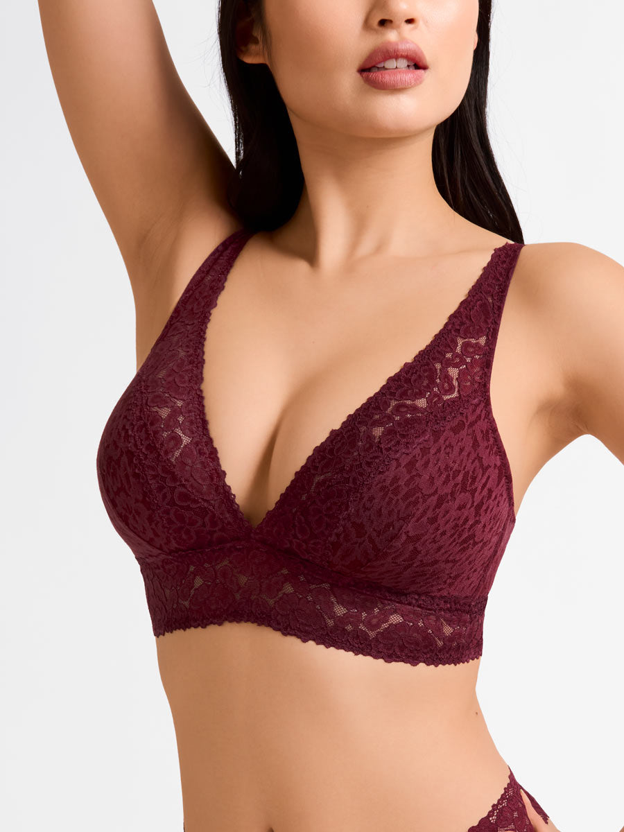 Woman wearing a maroon lace bralette from LoveSuze on a white background front view
