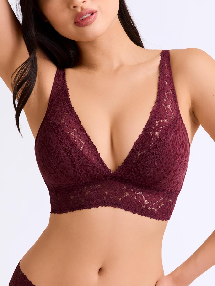 Woman wearing a maroon lace bralette from LoveSuze on a white background front view